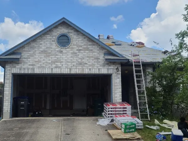 Re-roof on a brick home with materials staged