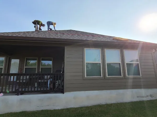 Crew installing new shingles