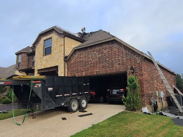 Tear-off underway with dump trailer