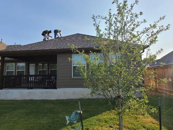 Crew finishing a single-story re-roof