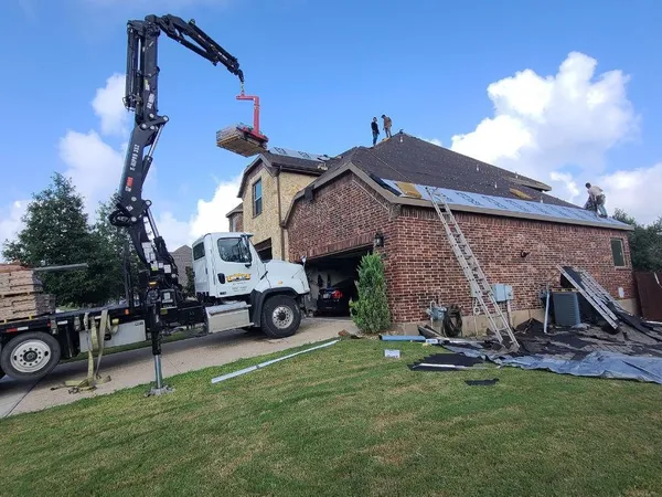 Boom truck delivering shingles