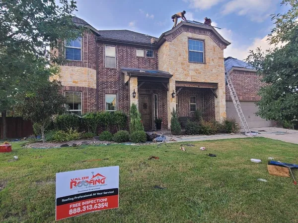 Two-story brick home with Valor yard sign